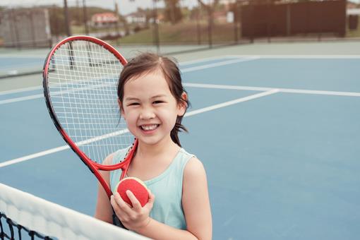 Girl with red tennis ball
