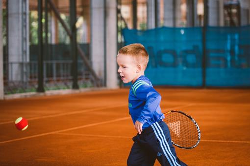 boy playing mini tennis
